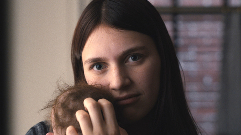 Nell Tiger Free as Leanne holding baby doll in Servant