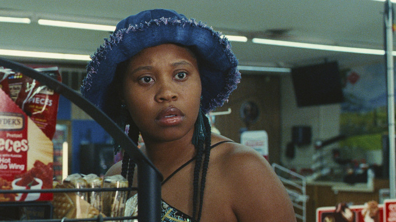 Dominique Fishback as Dre with blue hat in gas station in Swarm