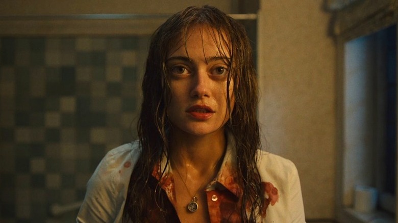 Ella Purnell as Rhiannon with wet hair and blood on shirt in Sweetpea