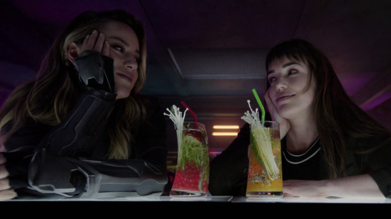 Chloe Bennet as Daisy Johnson and Elizabeth Henstridge as Jemma Simmons drinking on the planet Kitson while high in Agents of SHIELD