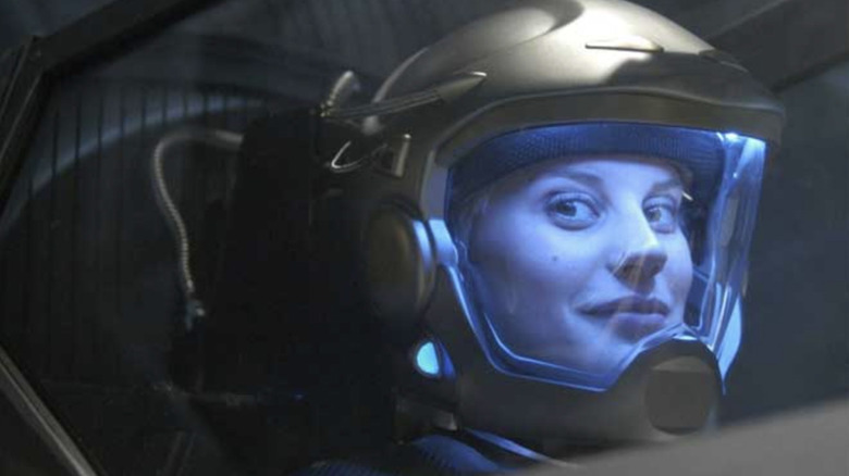 Katee Sackhoff as Kara "Starbuck" Thrace wearing a spacesuit in the cockpit of a ship in the Battlestar Galactica reboot