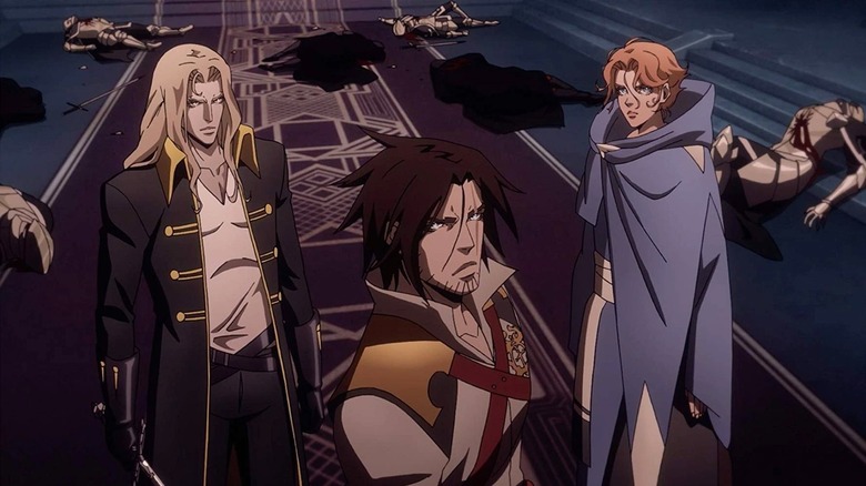 Alucard (James Callis), Trevor Belmont (Richard Armitage), and Sypha Belnades (Alejandra Reynoso) stand in a hallway around fallen enemies in Castlevania