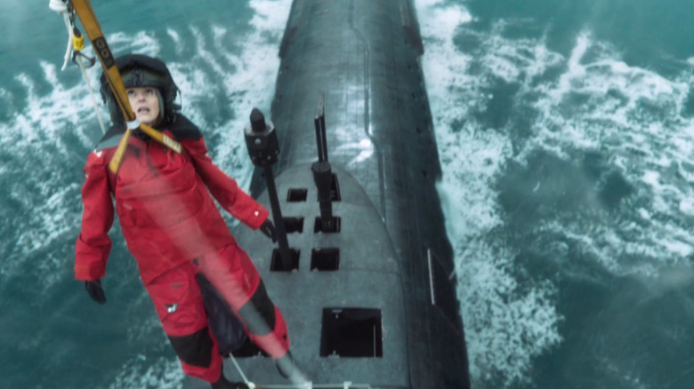 Suranne Jones as Amy Silva in red being lowered down onto submarine in Vigil