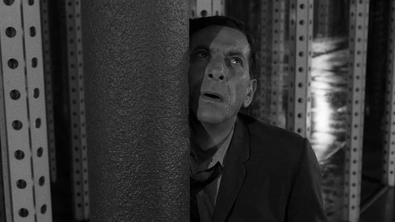 Max Phillips (Jack Klugman) stands physically struggling in a hall of mirrors in The Twilight Zone (1959)