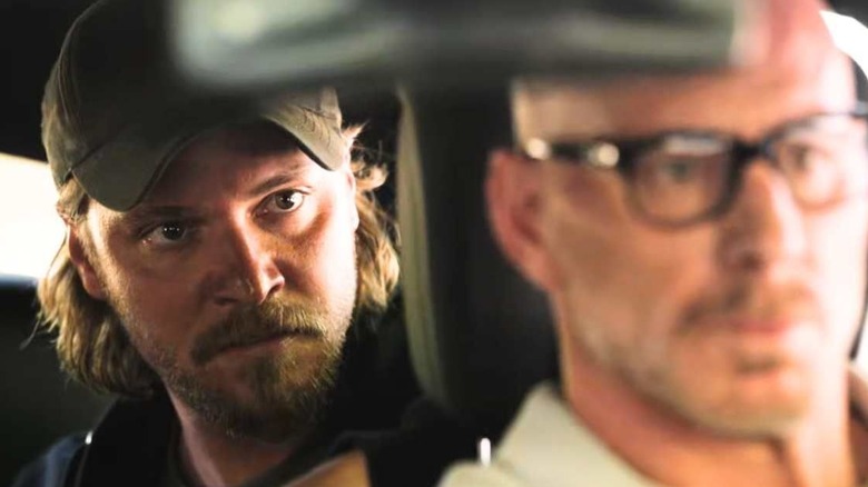 Kayce (Luke Grimes) and Grant (Matt Gerald) sitting in a car on "Yellowstone."