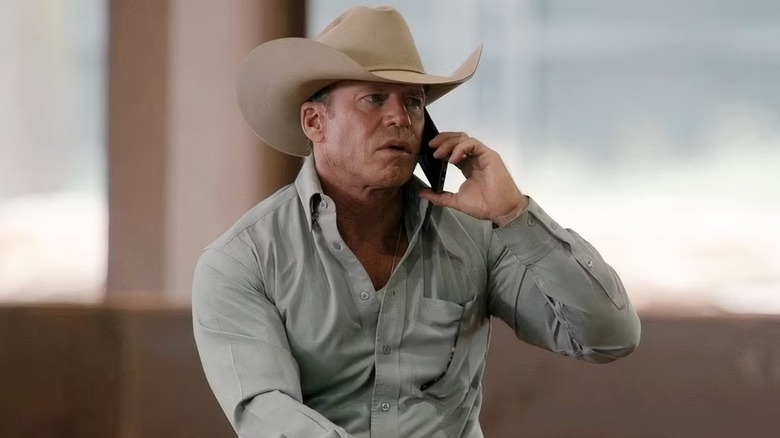 Travis Wheatley (Taylor Sheridan) holding a phone to his ear on "Yellowstone"