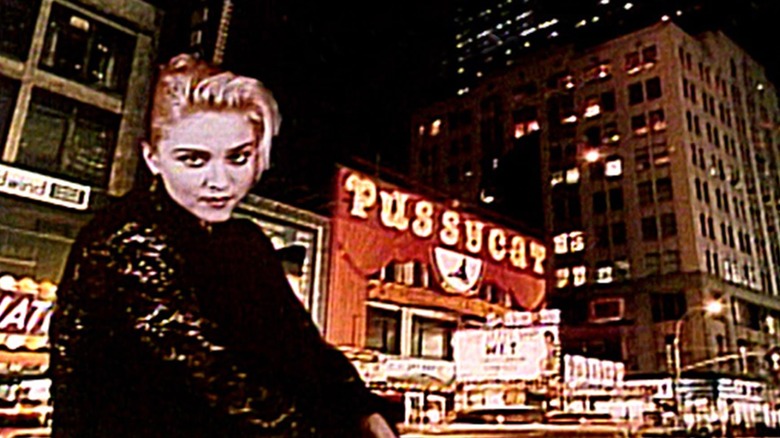 Madonna in front of a bustling NYC street at night in a bumper from SNL in 1985