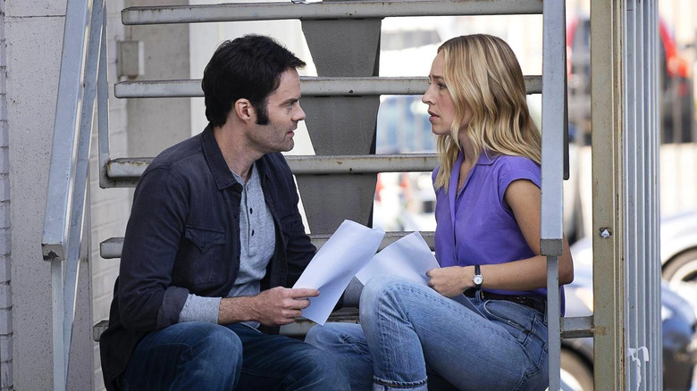 Bill Hader and Sarah Goldberg as Barry and Sally holding scripts on a staircase in Barry