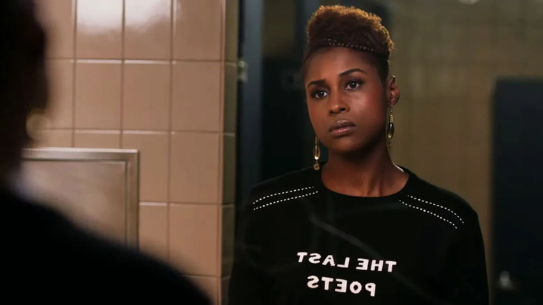 Issa Rae as Issa staring at herself in a mirror on Insecure