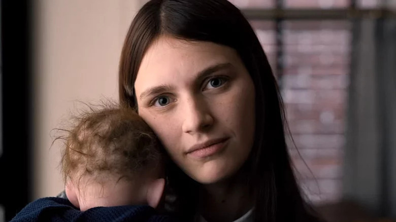 Leanne Grayson (Nell Tiger Free) cradles a baby in Servant