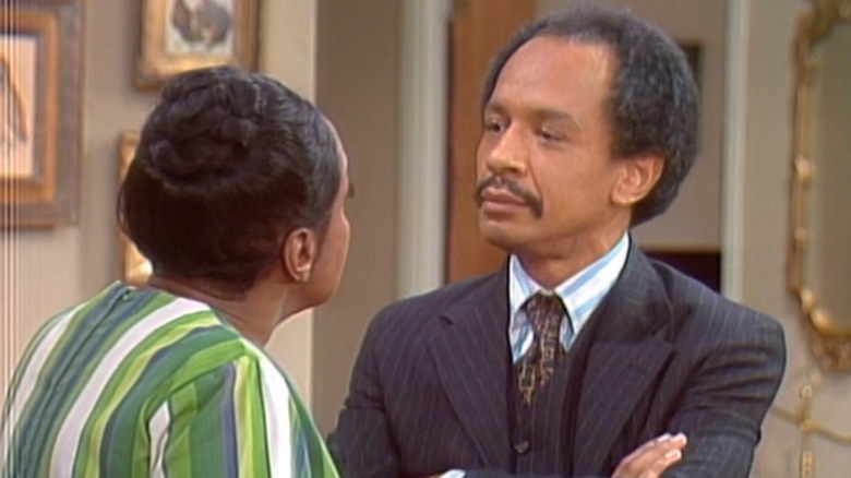George Jefferson (Sherman Hemsley) with arms crossed on The Jeffersons