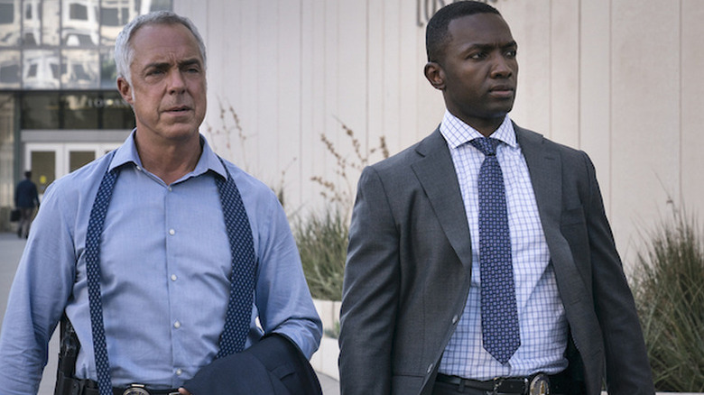 Harry Bosch (Titus Welliver) and Jerry Edgar (Jamie Hector) walk outside by a courthouse on Bosch