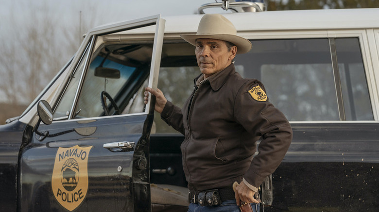 Joe Leaphorn (Zahn McClarnon) opens his police car door on Dark Winds