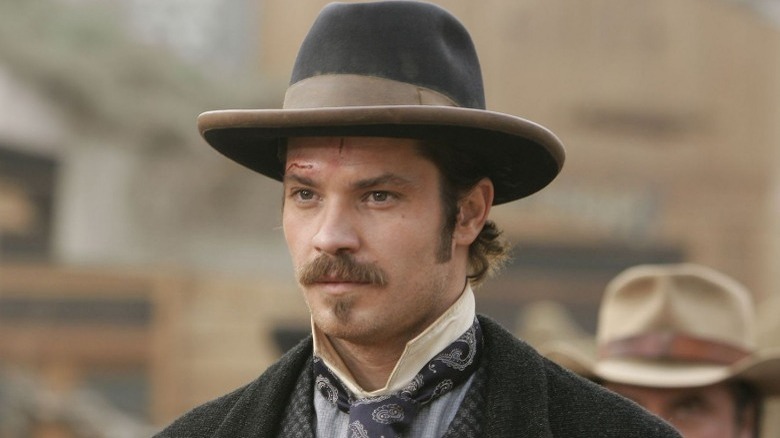 Seth Bullock (Timothy Olyphant) stands with a cut brow on Deadwood