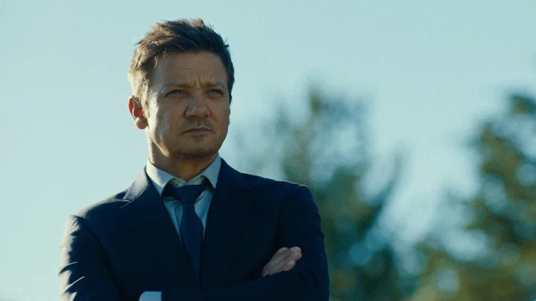 Mike McLusky (Jeremy Renner) stands outside with his arms crossed sternly on Mayor of Kingstown