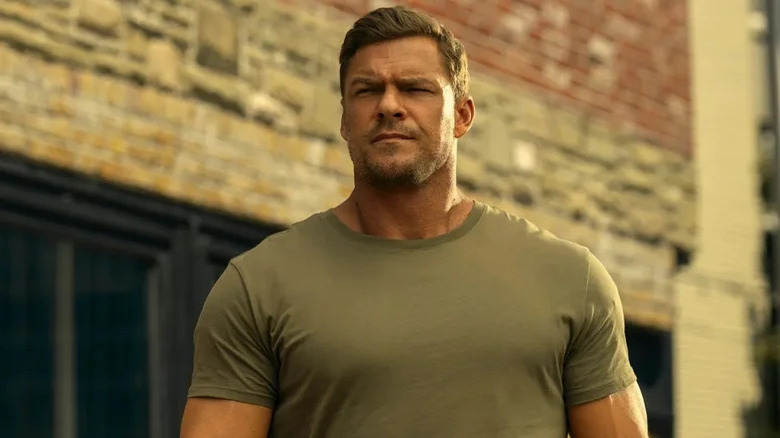 Jack Reacher (Alan Ritchson) stands outside impassively in Reacher