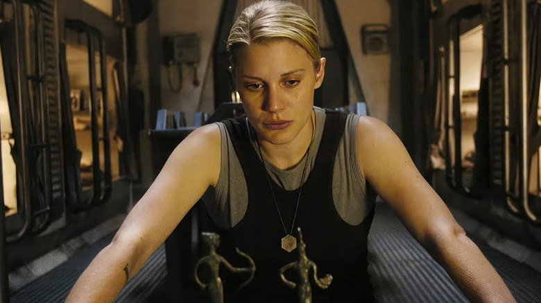 Starbuck (Katee Sackhoff) sits pensively in Battlestar Galactica (2004)