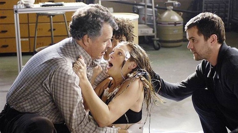 Walter Bishop (John Noble) holds a distraught Olivia Dunham (Anna Torv) with Peter Bishop (Joshua Jackson) in Fringe