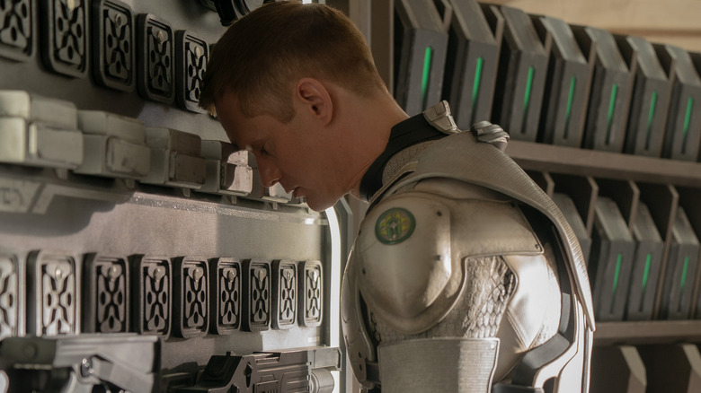 Murderbot (Alexander Skarsgård) rests his head against a wall in Murderbot