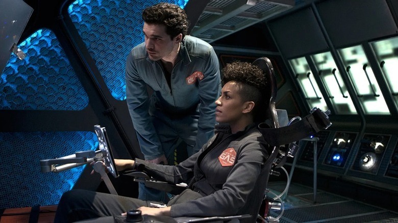 Naomi Nagata (Dominique Tipper) sits in Rocinante pilot's seat next to James Holden (Steven Strait) in The Expanse