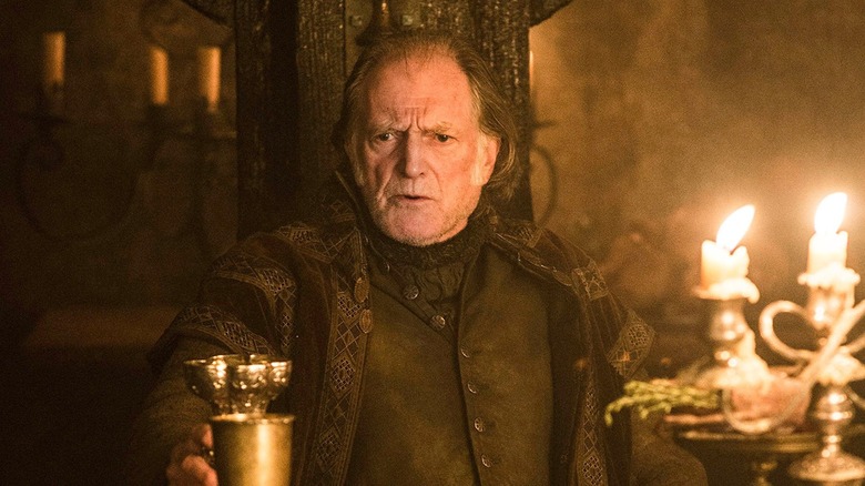 David Bradley as Walder Frey holds a cup in Game of Thrones