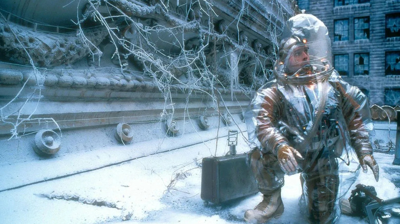 Bruce Willis as James Cole, donning a hazmat suit to explore a post-apocalyptic world in the movie "12 Monkeys."