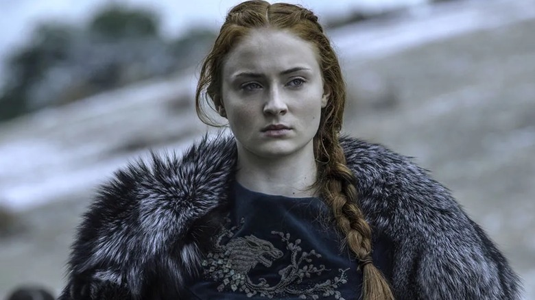 Sansa Stark (Sophie Turner) wearing a fur coat and braided hair on Game of Thrones