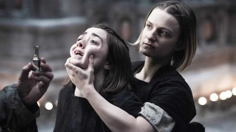 The Waif (Faye Marsay) forcibly holding Arya's (Maisie Williams) head on Game of Thrones