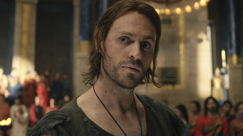 Sauron (Charlie Vickers) standing in a grand hall in The Lord of the Rings: The Rings of Power