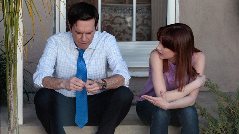 Andy Bernard (Ed Helms) and Erin Hannon (Ellie Kemper) have a serious conversation sitting on a stoop on The Office