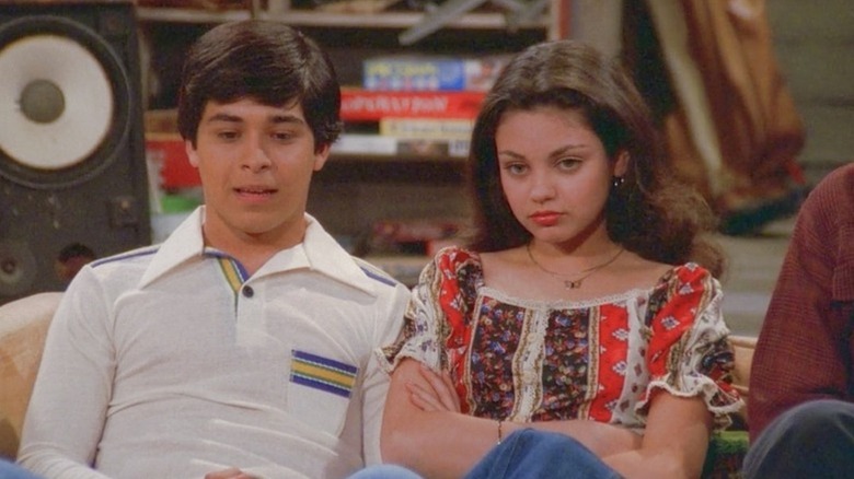 Fez (Wilmer Valderrama) sits next to Jackie Burkhart (Mila Kunis) on the basement couch on That '70s Show
