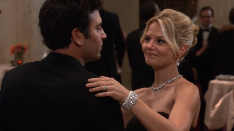 Zoey Pierson (Jennifer Morrison) smirks while dancing with a distant Ted Mosby (Josh Radnor) on How I Met Your Mother