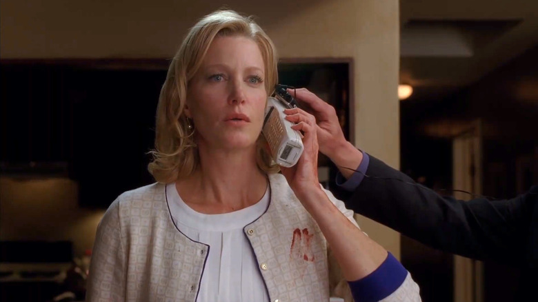 Stunned Skyler listening to Walt on the phone, surrounded by feds