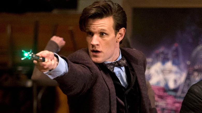 Matt Smith as the Doctor points a device on Doctor Who