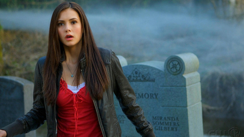 Elena Gilbert (Nina Dobrev) stands shocked in a cemetery on The Vampire Diaries
