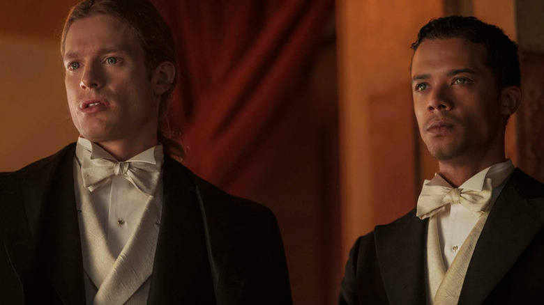 Lestat de Lioncourt (Sam Reid) and Louis de Pointe du Lac (Jacob Anderson) stand together wearing tuxedos in Interview with the Vampire