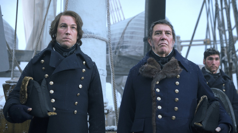 James Fitzjames (Tobias Menzies) and John Franklin (Ciarán Hinds) stand stoically in a ships deck in The Terror