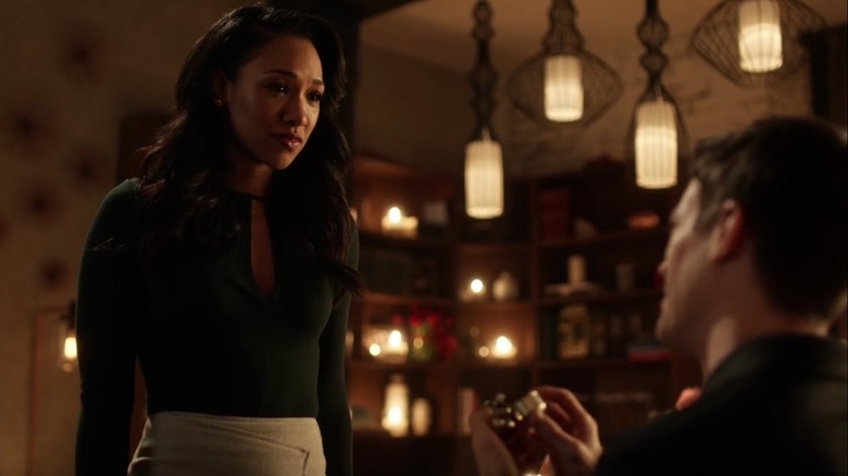 Iris West (Candice Patton) looks tearfully at Barry Allen (Grant Gustin) as he shows her a ring in The Flash
