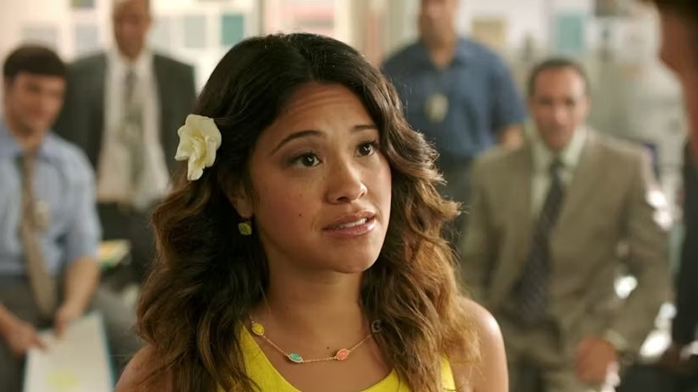 Jane Gloriana Villanueva (Gina Rodriguez) stands in an office in Jane the Virgin
