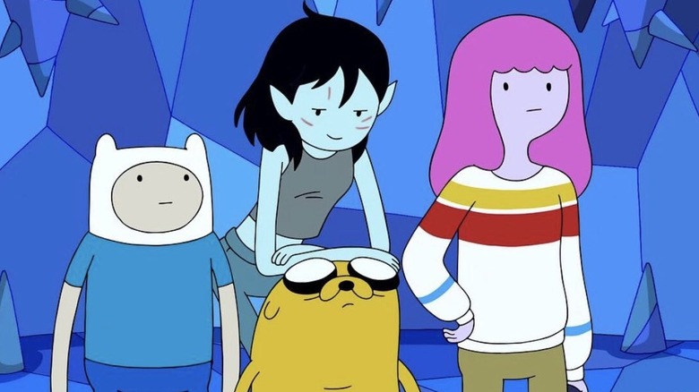 Finn looking at Marceline reclining on Jake the Dog next to Princess Bubblegum in a sweater in Adventure Time