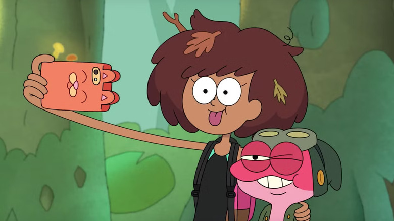 Anne taking a selfie with her tongue out and her arm around Sprig in Amphibia