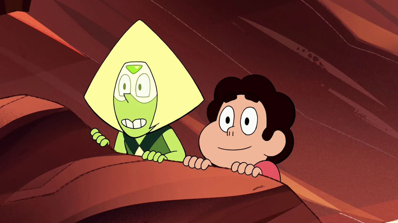 Peridot and Steven hiding behind a red rock in Steven Universe