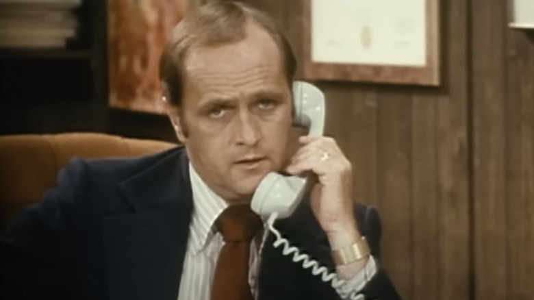 Dr. Robert Hartley (Bob Newhart) answers the phone in The Bob Newhart Show