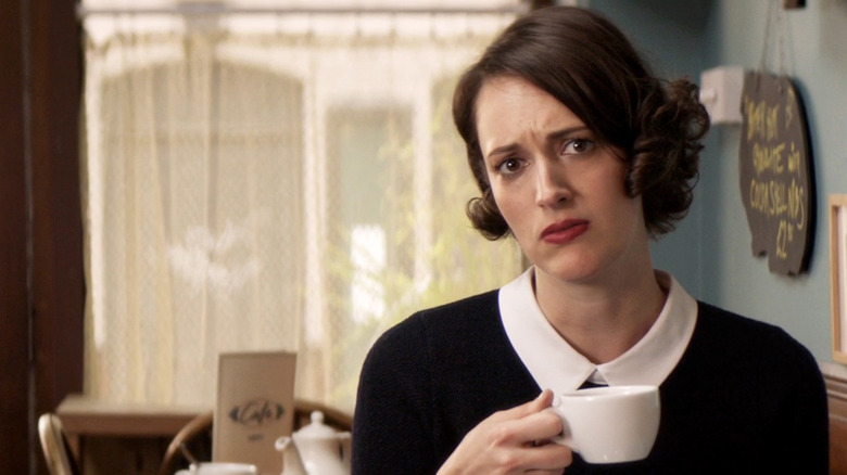 Phoebe Waller-Bridge as Fleabag staring into camera holding a teacup in Fleabag