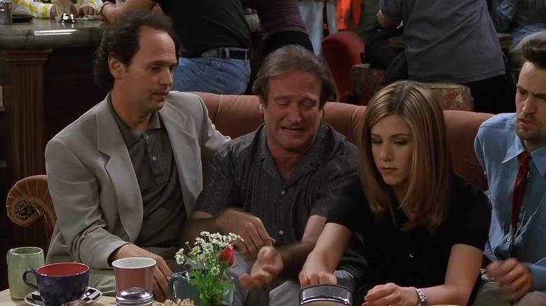 Billy Crystal, Robin Williams, Jennifer Aniston, and Matthew Perry sharing a couch as Tim, Tomas, Rachel, and Chandler on Friends
