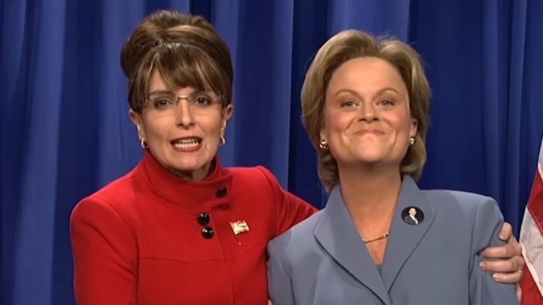 Tina Fey and Amy Poehler as Sarah Palin and Hillary Clinton stand together on SNL