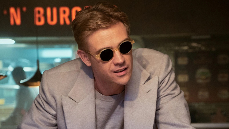 Boyd Holbrook as The Corinthian, leaning over a table in The Sandman.