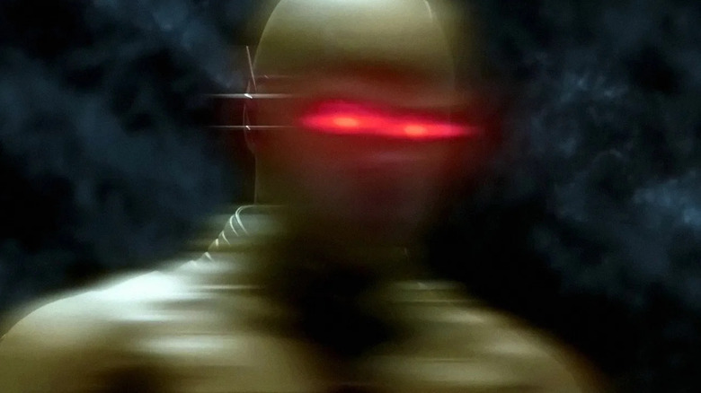 Tom Cavanagh as the Reverse-Flash, appearing in a blur with red eyes in The Flash.
