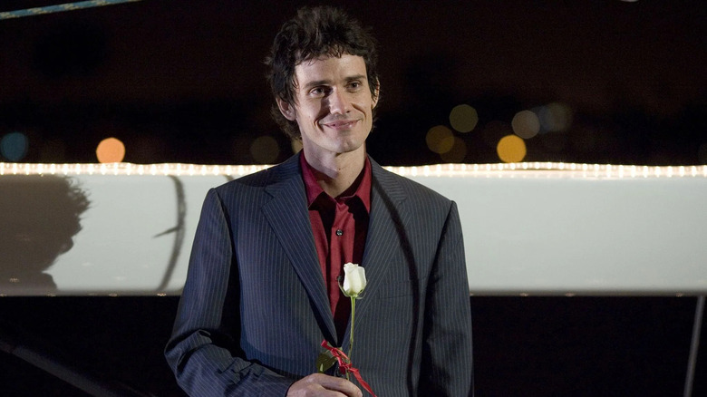 Christian Camargo as Rudy Cooper, holding a rose and smiling in Dexter.