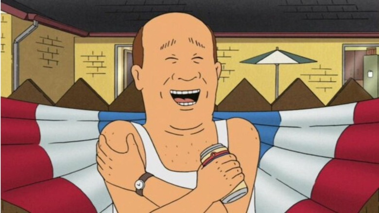 Bill laughs in front of star-spangled bunting, holding a beer in King of the Hill.